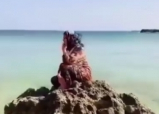 مسنة تجلس على ساحل البحر في درنة انتظارا لخروج جثامين أقاربها وجيرانها