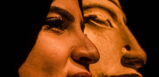 المصورة إيمان عرب إلى جانب تمثال الملك أخناتون