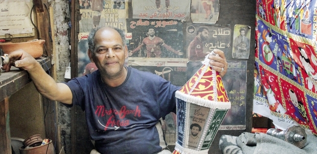 «خالد» أمام فانوس ولوحات عليها صورة محمد صلاح