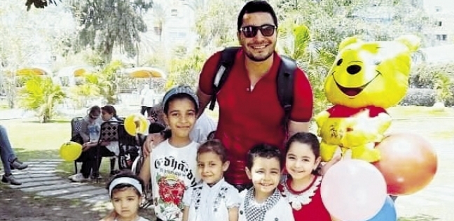 «مصطفى» مع الأطفال فى إحدى فعاليات الخير