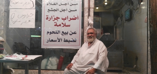 «طارق» يعلق لافتات «مقاطعة» اللحمة أمام محله