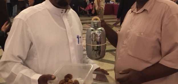 سعوديان يشاركان الناخبين بتمر وقهوة