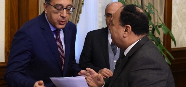 «مدبولى» ووزير المالية خلال مناقشة جانبية بمجلس الوزراء