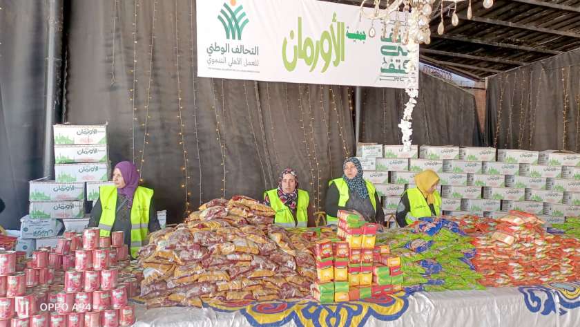 متطوعو «كتف في كتف» أثناء إعداد المواد الغذائية فى محافظة الفيوم لتوزيعها على الأكثر احتياجاً