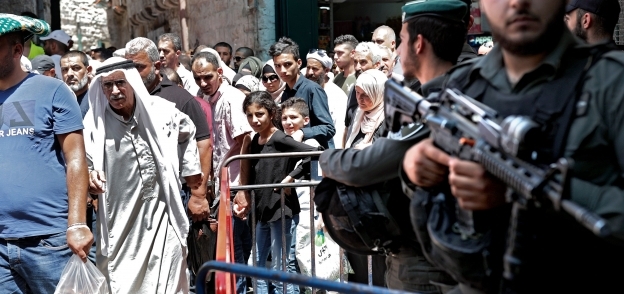 فلسطينيون خلال ذهابهم لأداء صلاة الجمعة فى القدس وسط إجراءات أمنية مشددة من قبل قوات الاحتلال الإسرائيلى «أ.ف. ب»