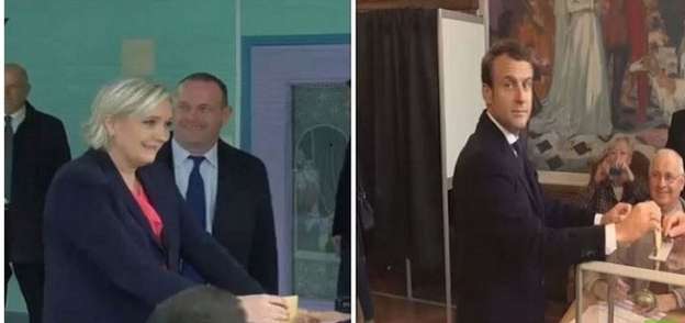 ماكرون ولوبان يدليان بصوتيهما في الانتخابات الفرنسية وسط حفاوة مؤيديهما