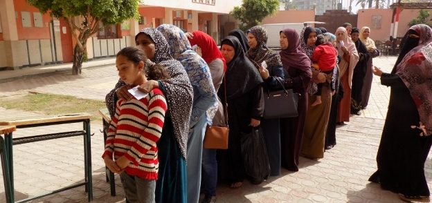 صورة سيدات تقفن أمام رقم 20 بمدرسة الشهيد اللواء أحمد زكي بالفيوم