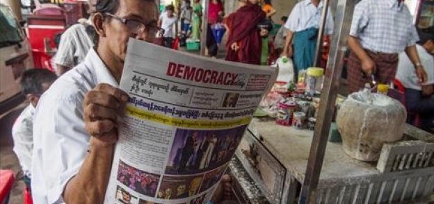 أحد المواطنين في بورما يقرأ الصحفية التي تصدر "ترامب"في صفحتها الأولى