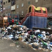 أكوام القمامة منتشرة فى شوارع إمبابة