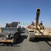 القوات العراقية مدعومة بمقاتلى الحشد بعد السيطرة على أحد المواقع بـ«كركوك» «أ. ف. ب»