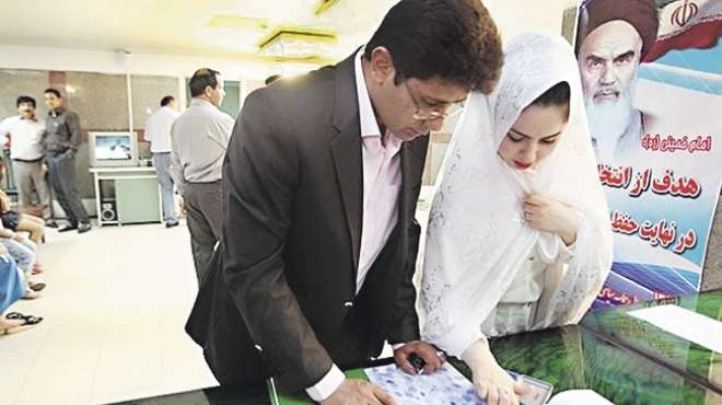 عروسان يدليان بصوتيهما فى الانتخابات الإيرانية «ومعاهم المعازيم»