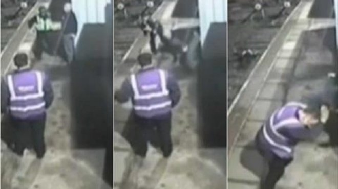 بالفيديو| رجل مخمور يدفع ضابط شرطة على قضبان السكك الحديدية