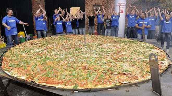 60 طباخا يعدون أطول بيتزا في العالم بإيطاليا 