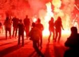 ملثمون يشعلون النيران في إطارات الكاوتشوك أمام فندق سميراميس