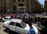  مجندو الأمن المركزي يلوحون بإشارات خارجة للمتظاهرين من شرفات دار القضاء 